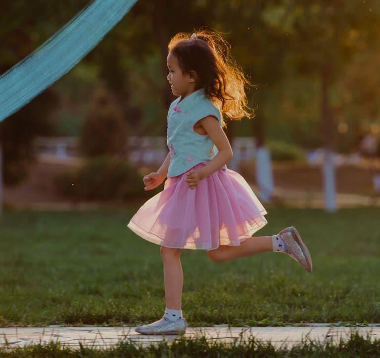 Girl running in field | Midline Community in Texas