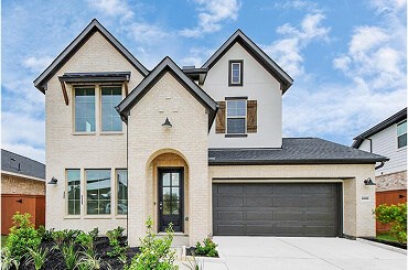 Two-story new construction home with steep gables and brick exterior in League City, TX