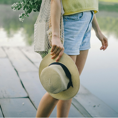 Woman holding sunhat | Midline Community near Houston, Texas