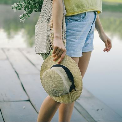 Woman holding sunhat | Midline Community near Houston, Texas
